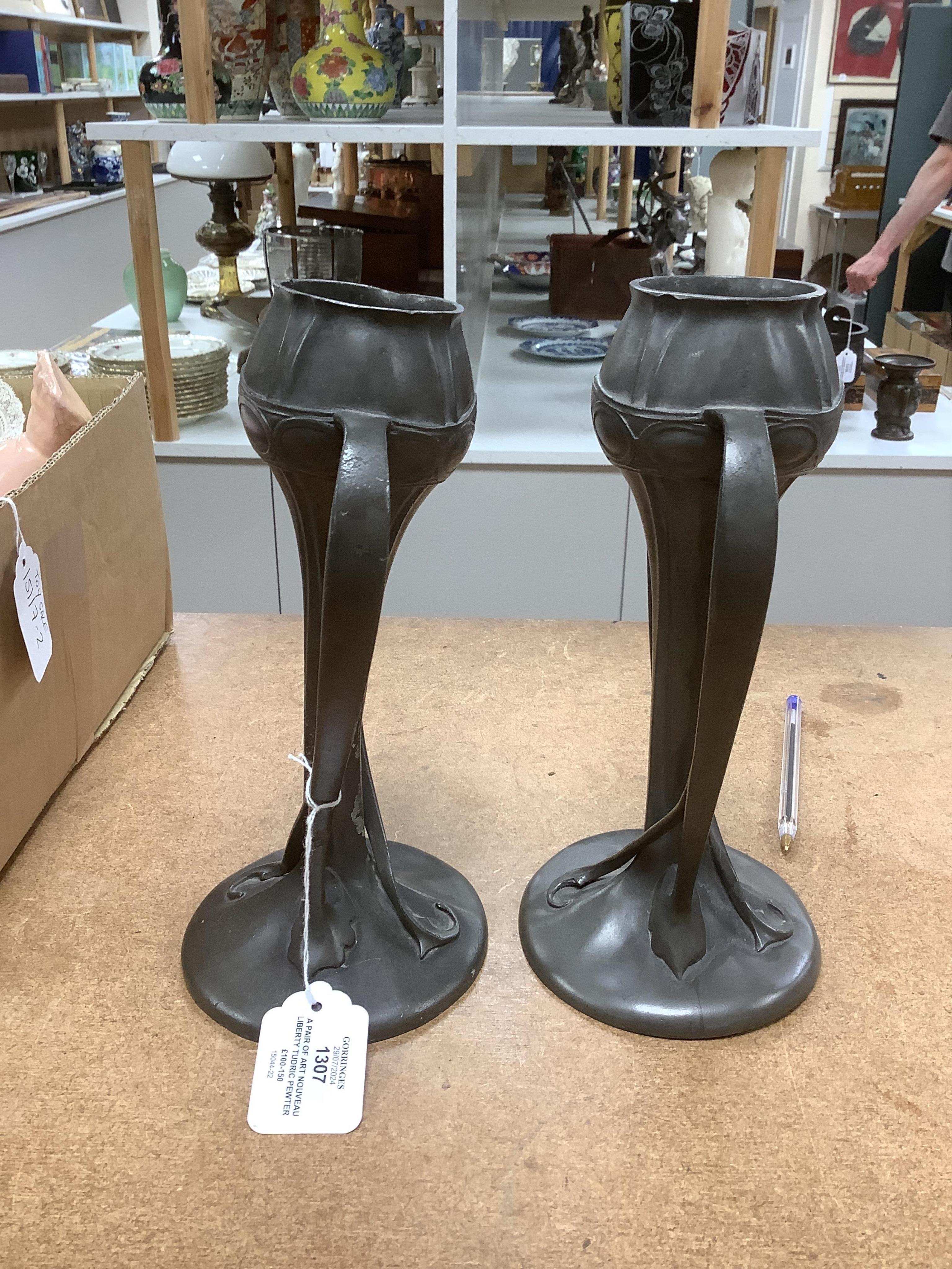 A pair of Art Nouveau Liberty Tudric pewter twin-handled vases, stamped to the bases, 25cm high. Condition - one good, the other poor to fair